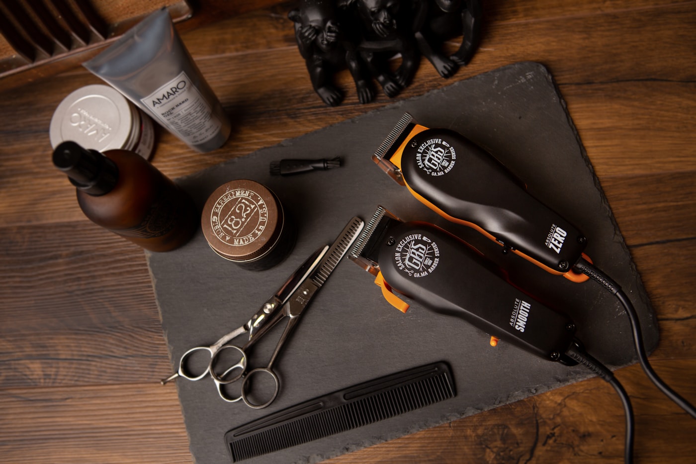 Barbering tools laid out on a slate board